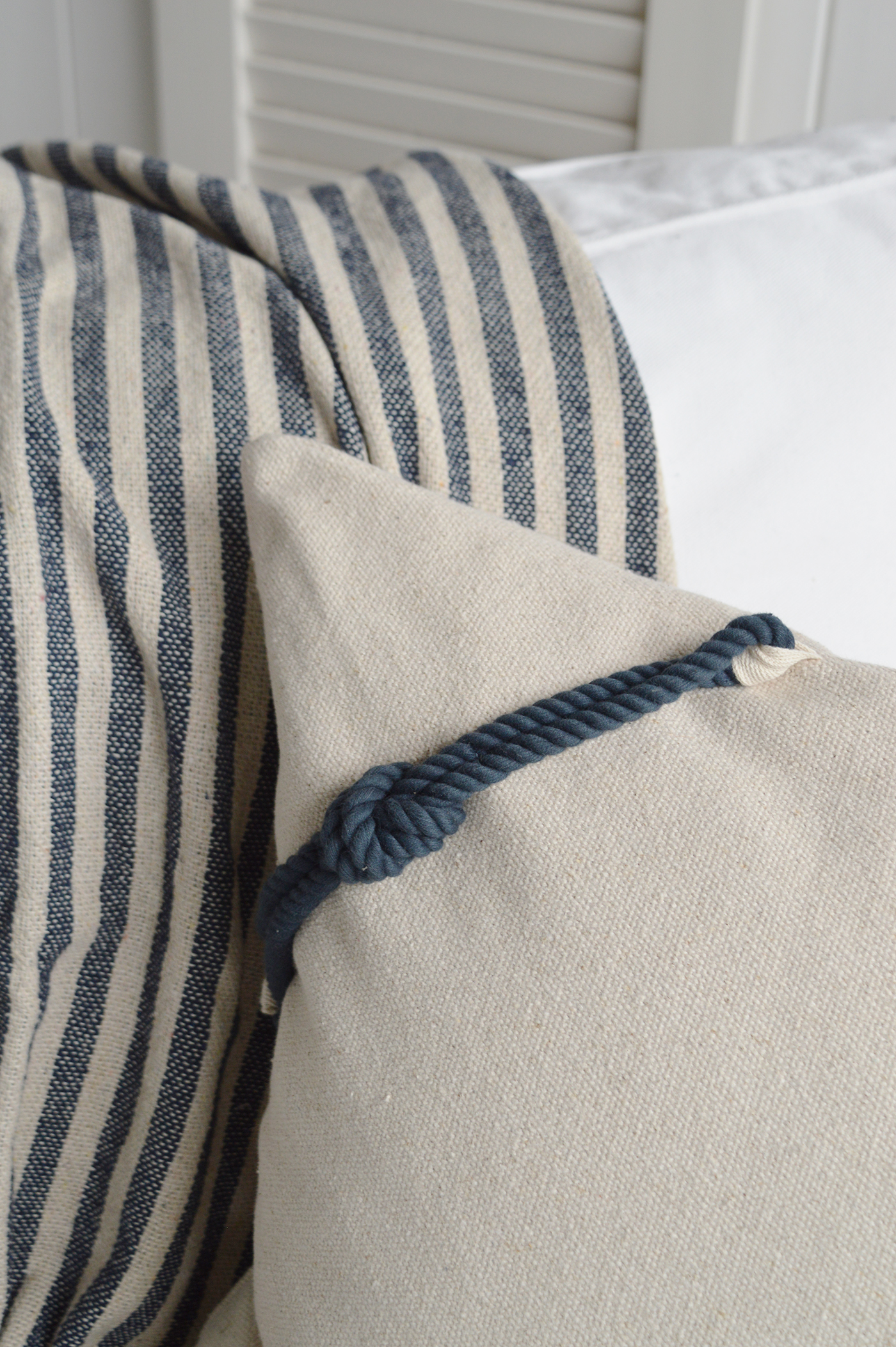 A close up image to show the finishes and fabric of the coastal cushion and throw to style New England coastal Hamptons Beach Homes 