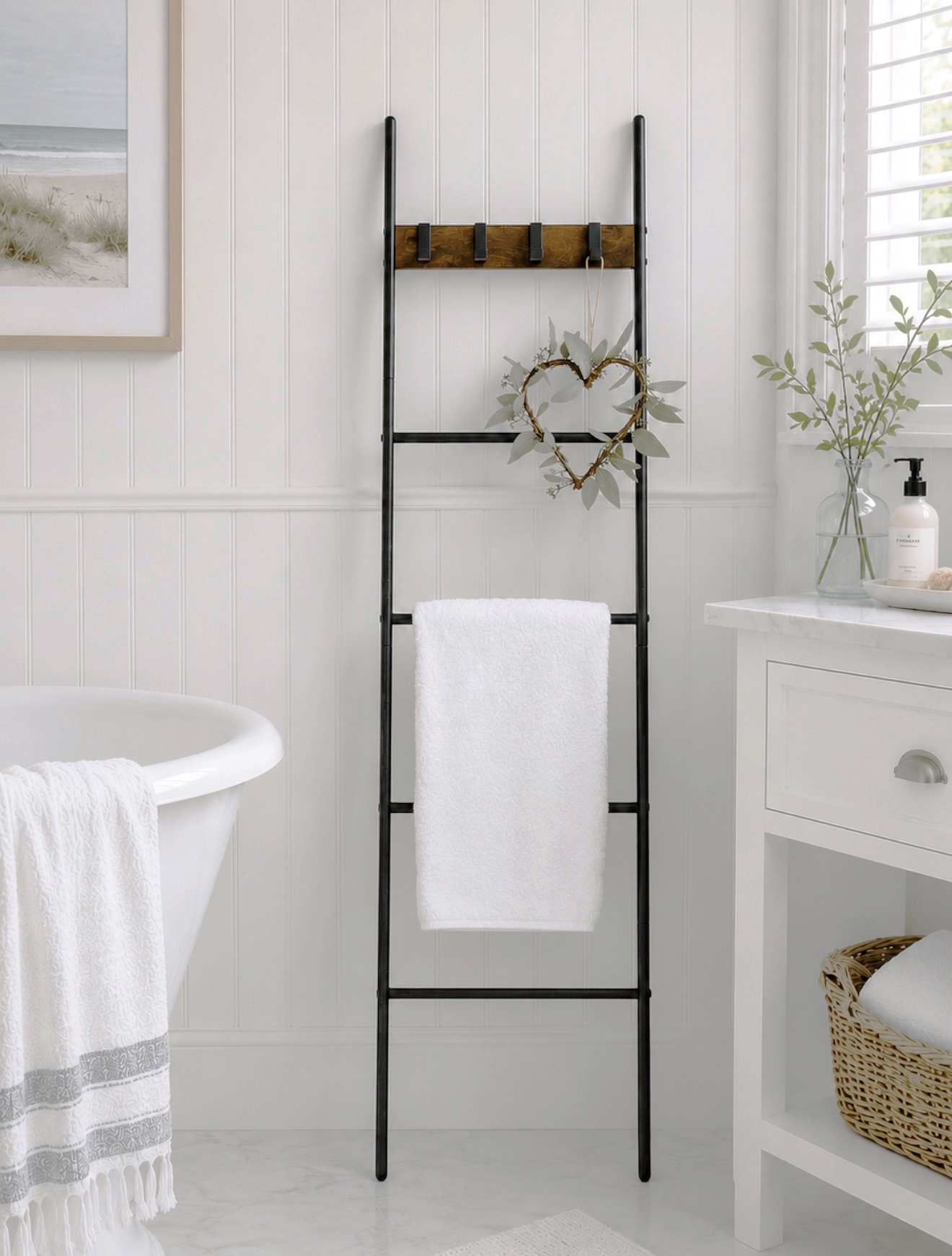 A stylish ladder towel rail bringing practical storage and relaxed Hamptons coastal style to a light, airy and elegant bathroom interior.