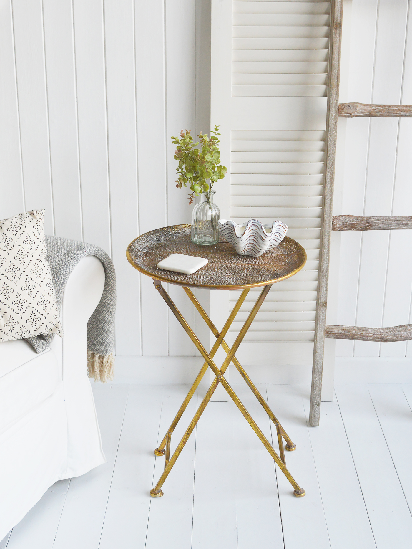 The Charleston table, a contrasting antiqued gold side table againes the neutral Hamptons living room