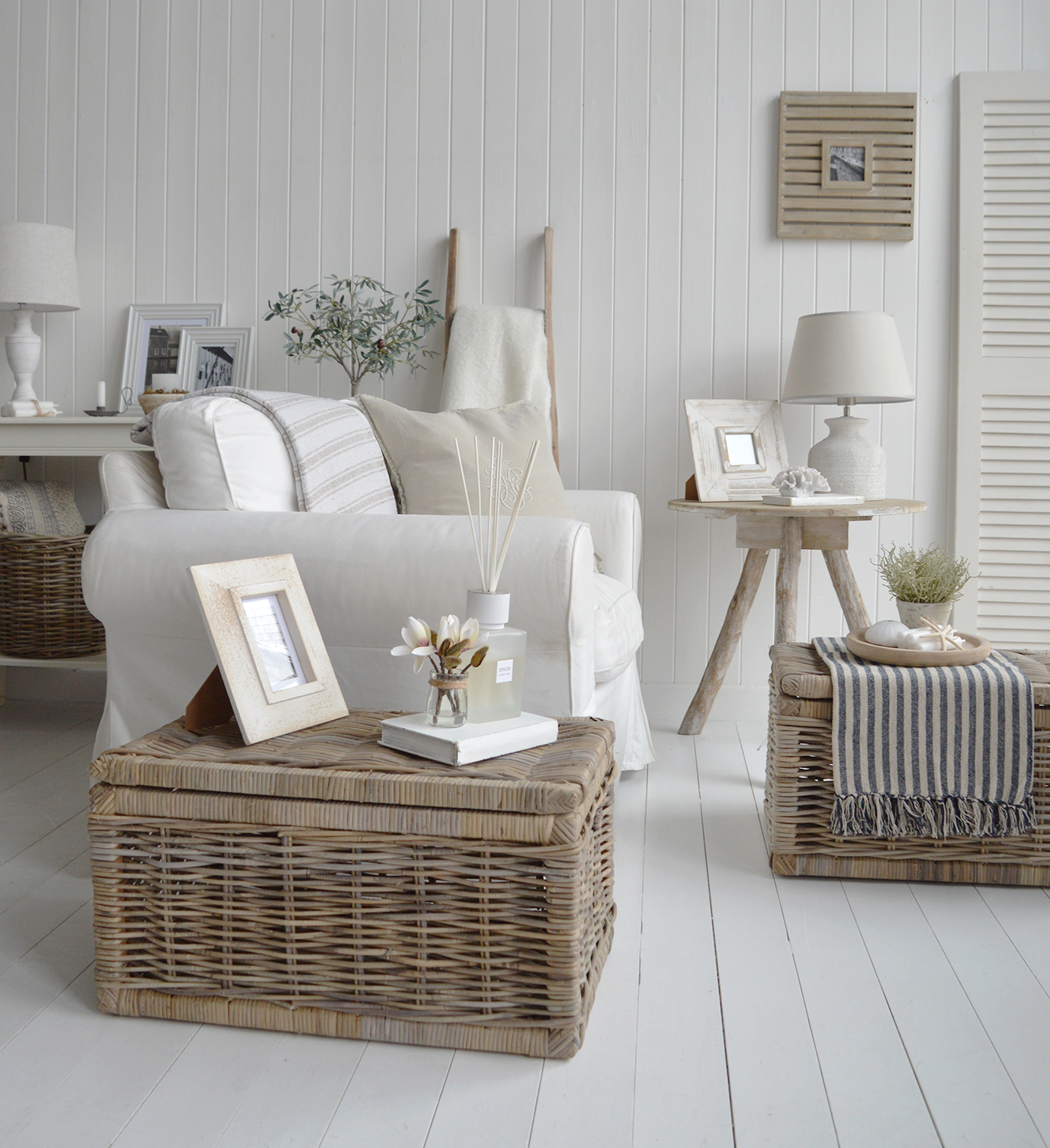 A serene coastal living room in netural colours with texture and warmth from the natural materials of the Driftwood table and Seadise basket tables