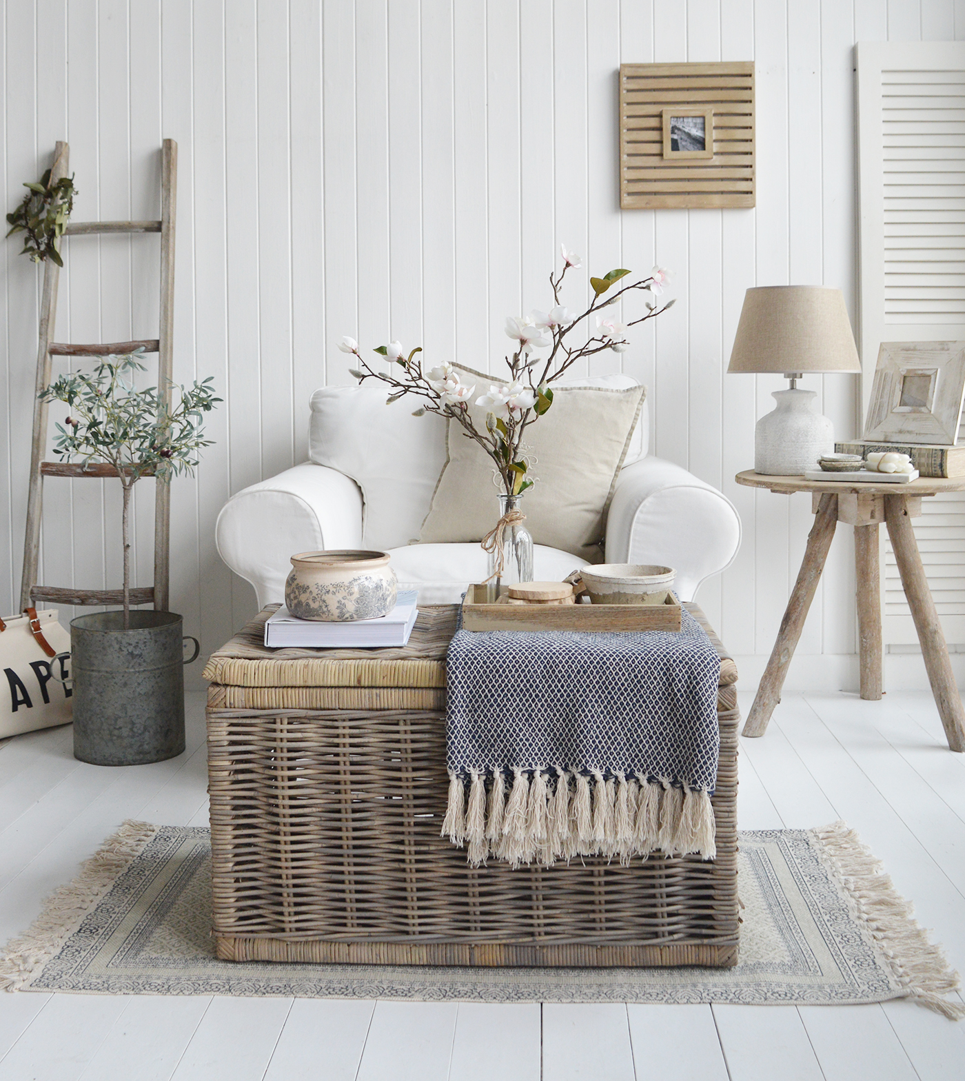 The Seaside cottage coffee table styled with a navy throw and rustic pieces