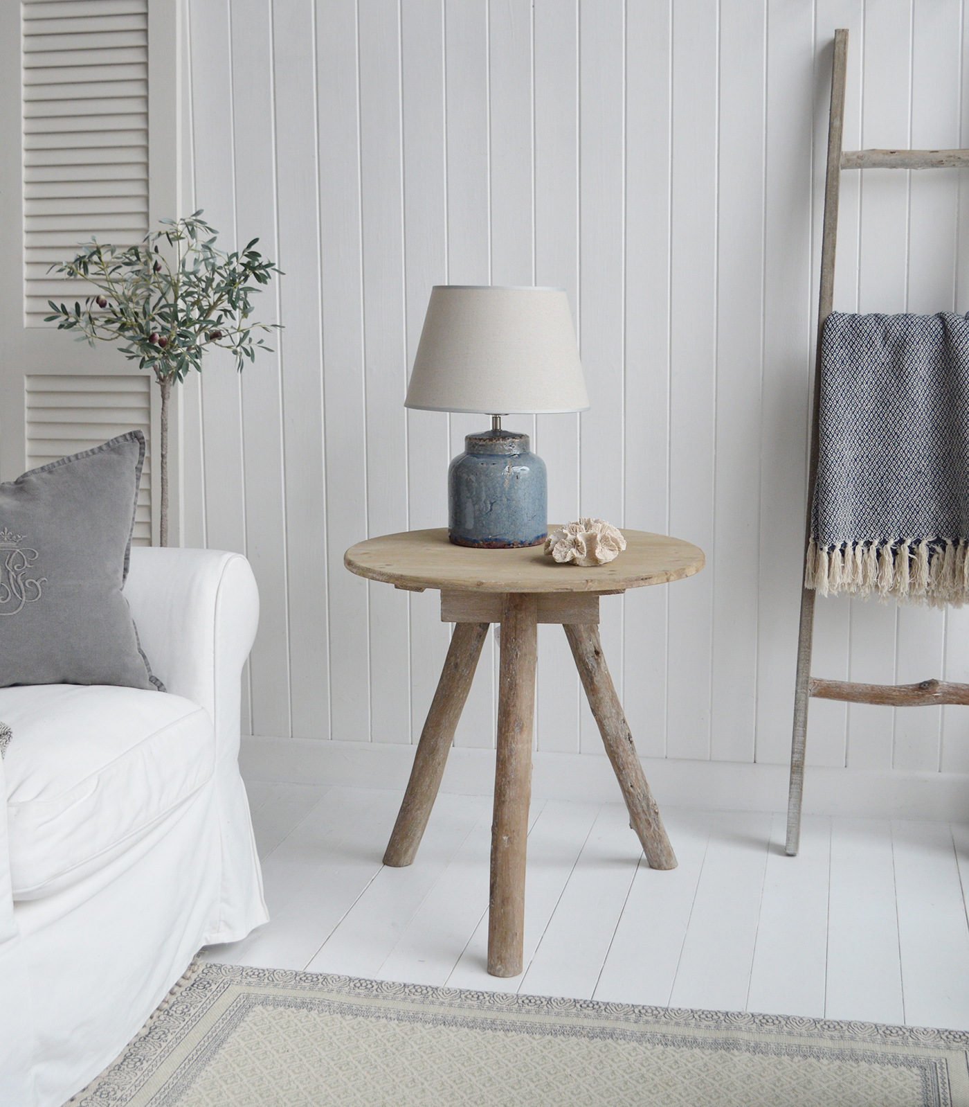 The Driftwood wooden table withthe Blue Compton lamp in a coastal inspired living room