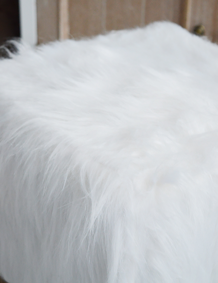 The Woodstock square white faux sheepskin fur stool with four contrasting legs in a rich coloured wood. Inspired by the laid back style of New England living in the country, by the coast and in the city, our beautiful Woodstock white foot stool adds warmth and texture to a room while offering extra seating and a comfortable place to rest your feet.