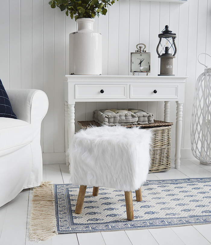 The Woodstock square white faux sheepskin fur stool with four contrasting legs in a rich coloured wood. Inspired by the laid back style of New England living in the country, by the coast and in the city, our beautiful Woodstock white foot stool adds warmth and texture to a room while offering extra seating and a comfortable place to rest your feet.