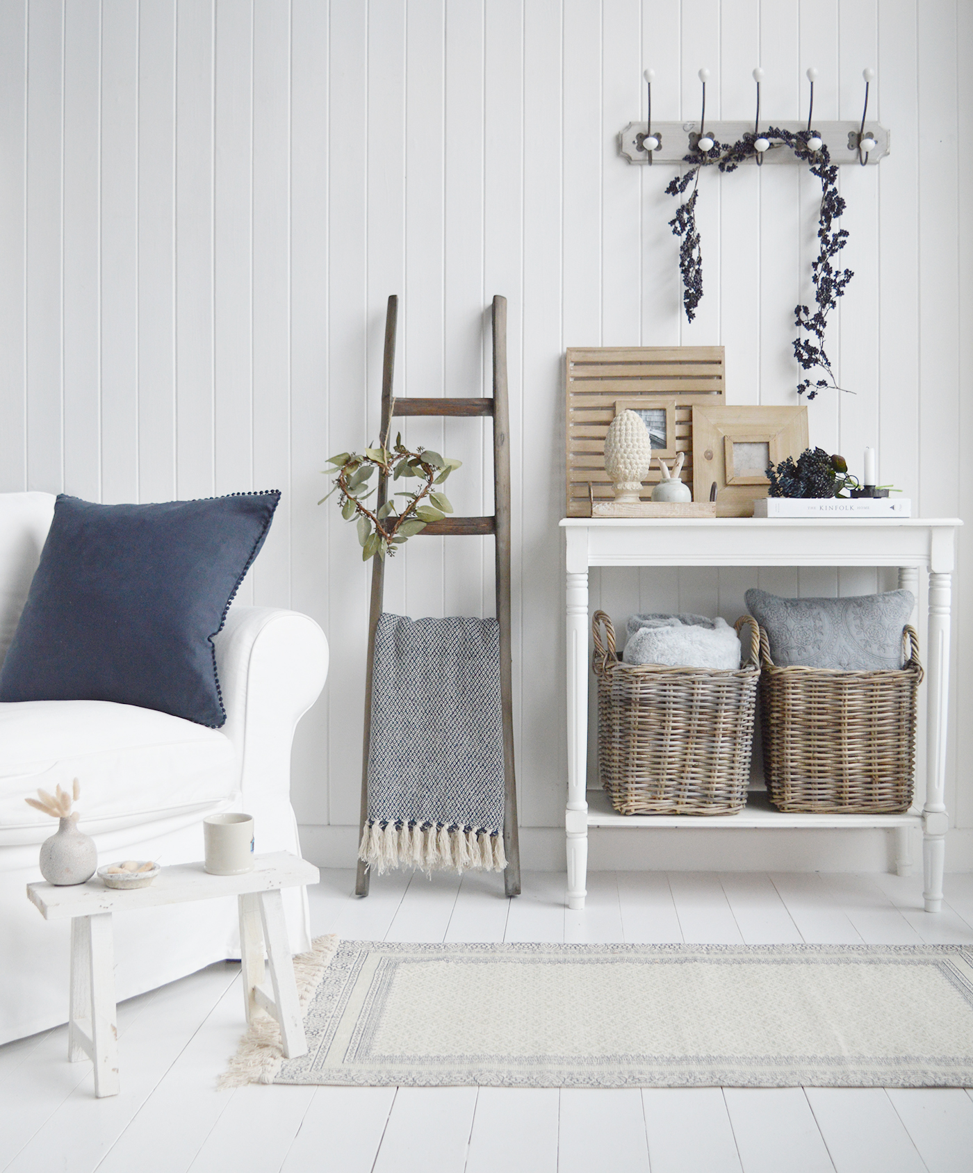 New England style living room with baskets, rugs and blankets for plenty of texture