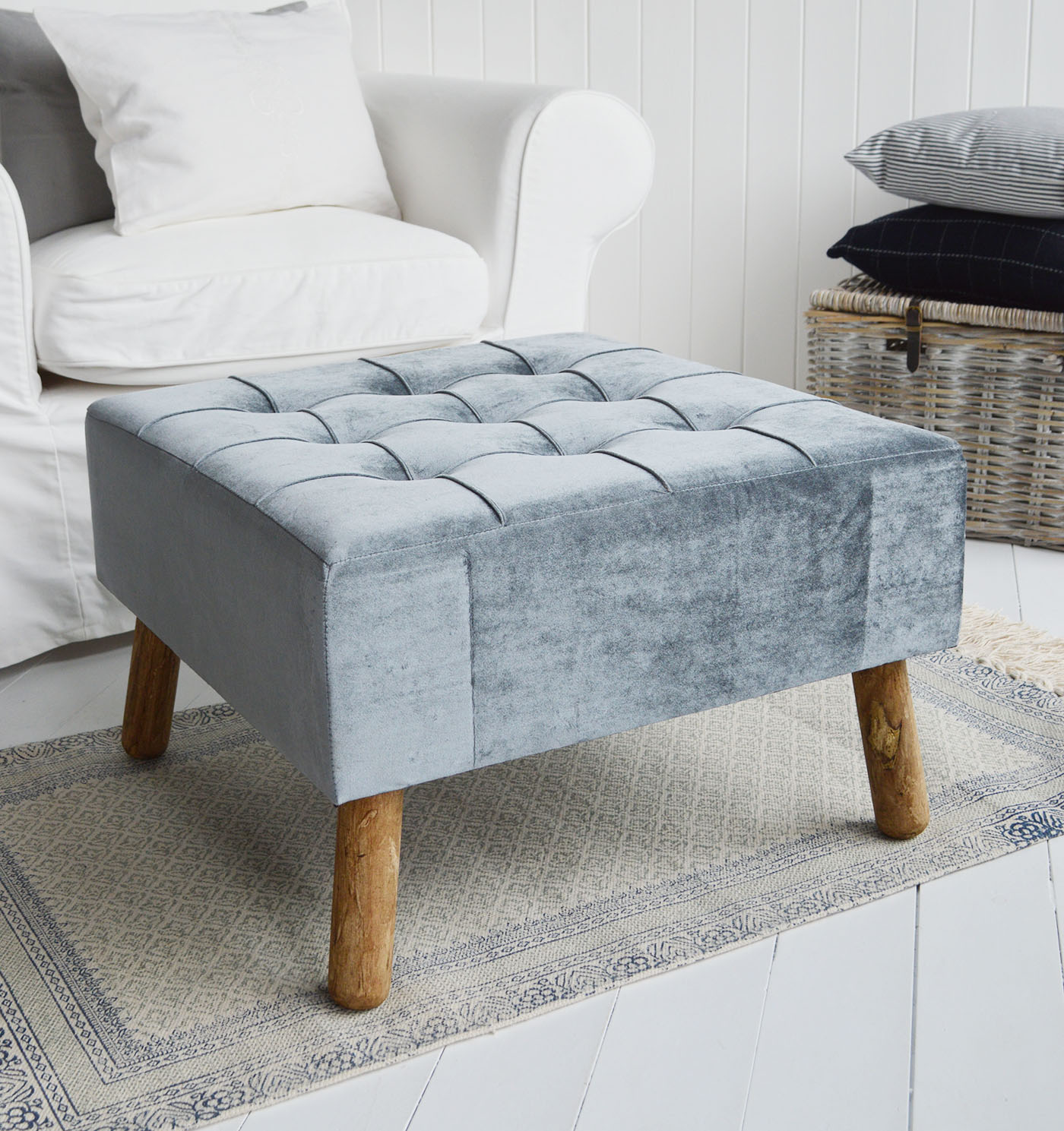 The New London footstool and ottoman in a buttoned luxurious blue grey velvet with aged oak coloured legs.A beautiful classic, timeless addition for all New England style homes in the country, by the coast and in the city.