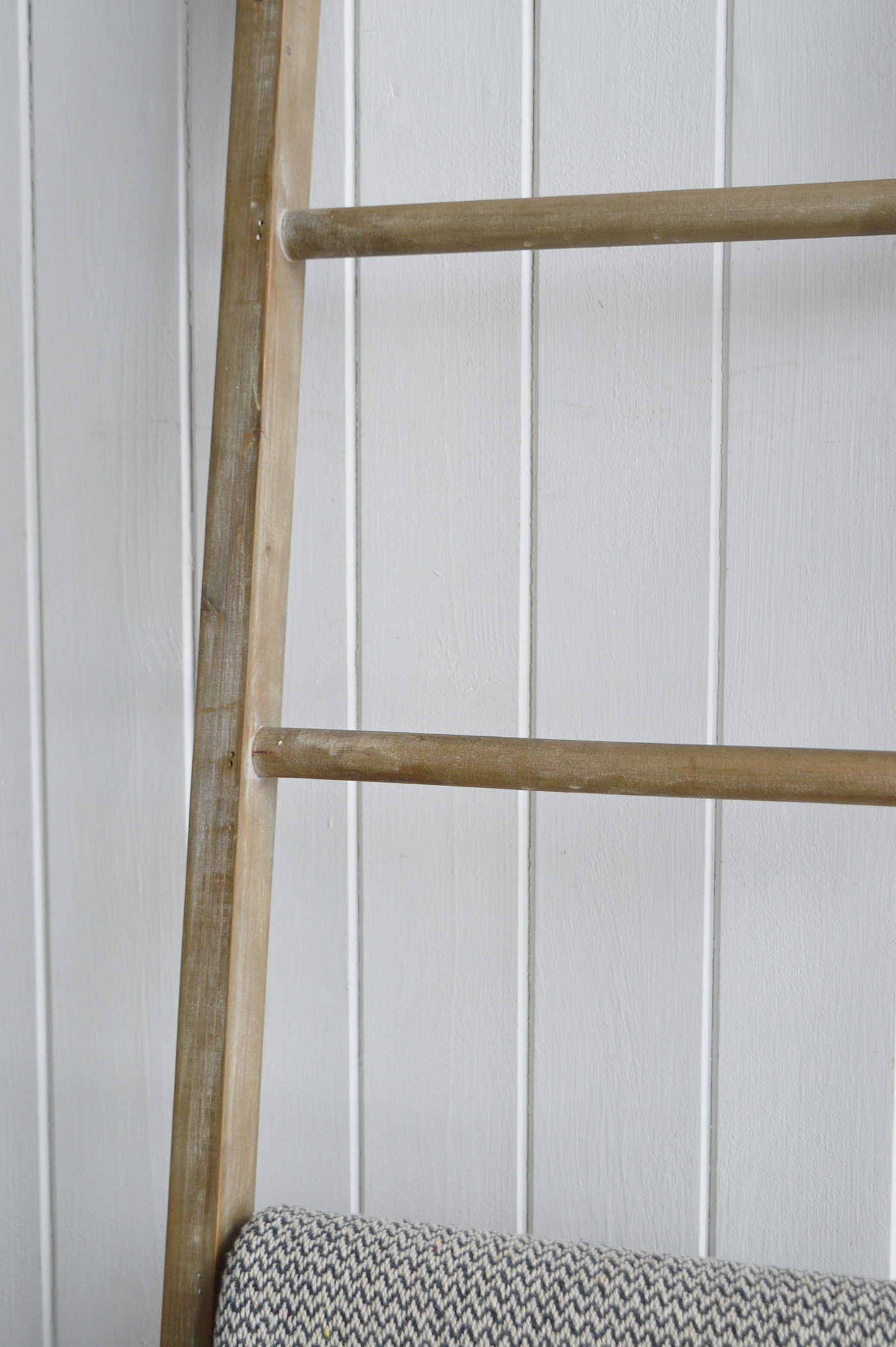 This interior captures the relaxed sophistication of Hamptons style with its clean lines, natural palette, and effortless textures. The ladder, stool, and simple greenery bring a touch of farmhouse charm, balancing coastal freshness with homely warmth.