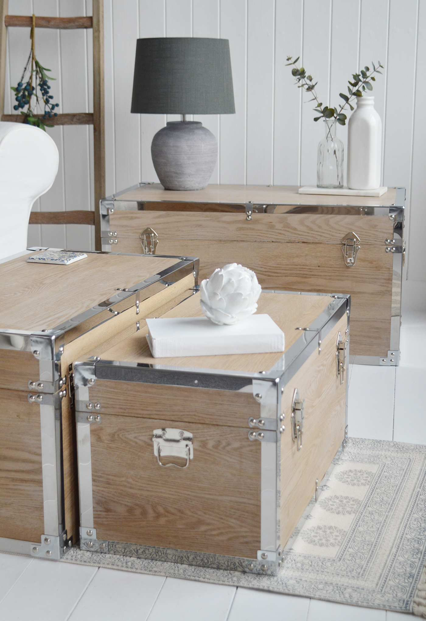 Vermont white washed storage trunks from The White Lighthouse. New England style furniture for coastal, country, farmhouse, cottage and city homes and interiors. Living Room, hallway and bedroom storage furniture