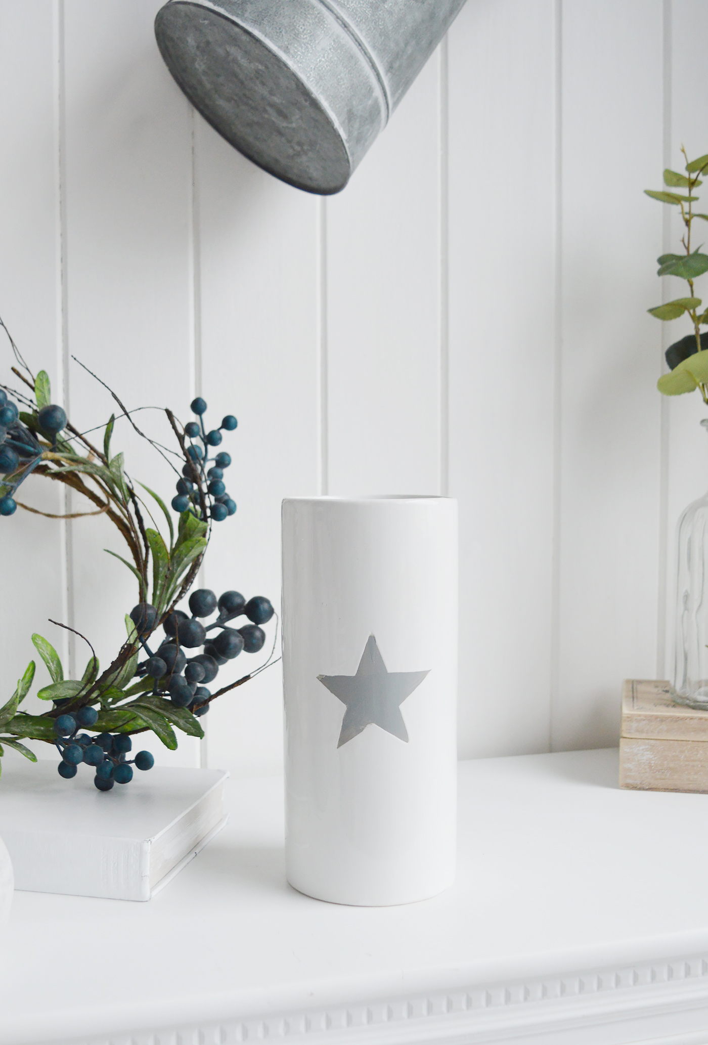 White ceramic vase with grey star for white homes and interiors