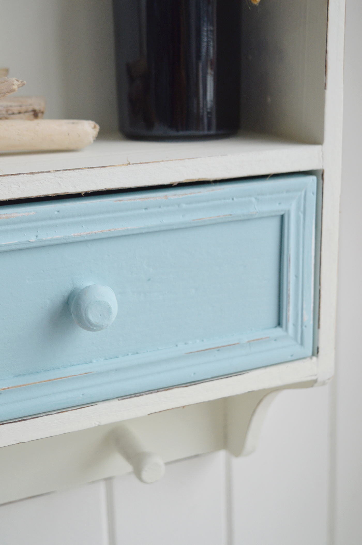 The soft blue and white finish makes this rustic wall storage unit a lovely addition to relaxed coastal interiors.