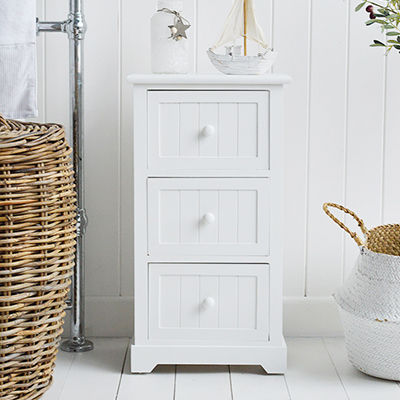 A white wooden cabinet with three drawers, ideal in a bathroom for essential storage of toiletries and make up.

