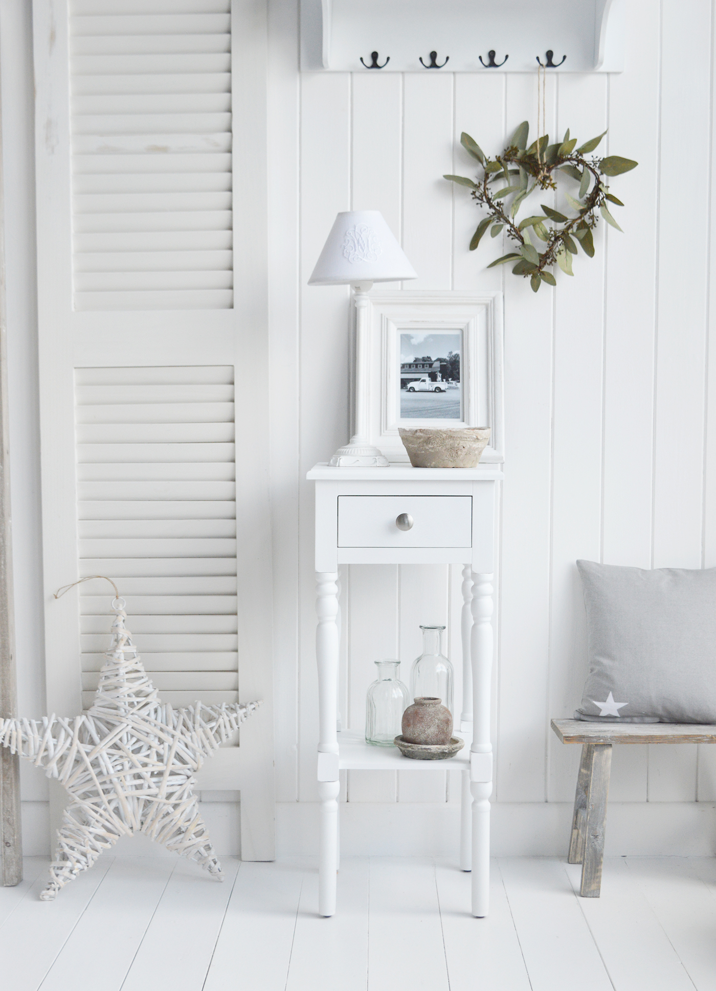 The White Lighthouse bedroom furniture. A narrow white bedside table with drawer and silver handle, can be used as a white lamp table from The Georgetown range