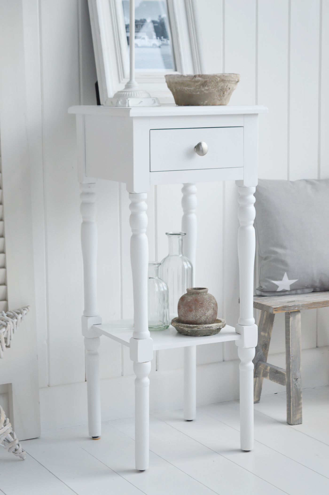 The White Lighthouse bedroom furniture. A narrow white bedside table with drawer and silver handle, can be used as a white lamp table from The Georgetown range