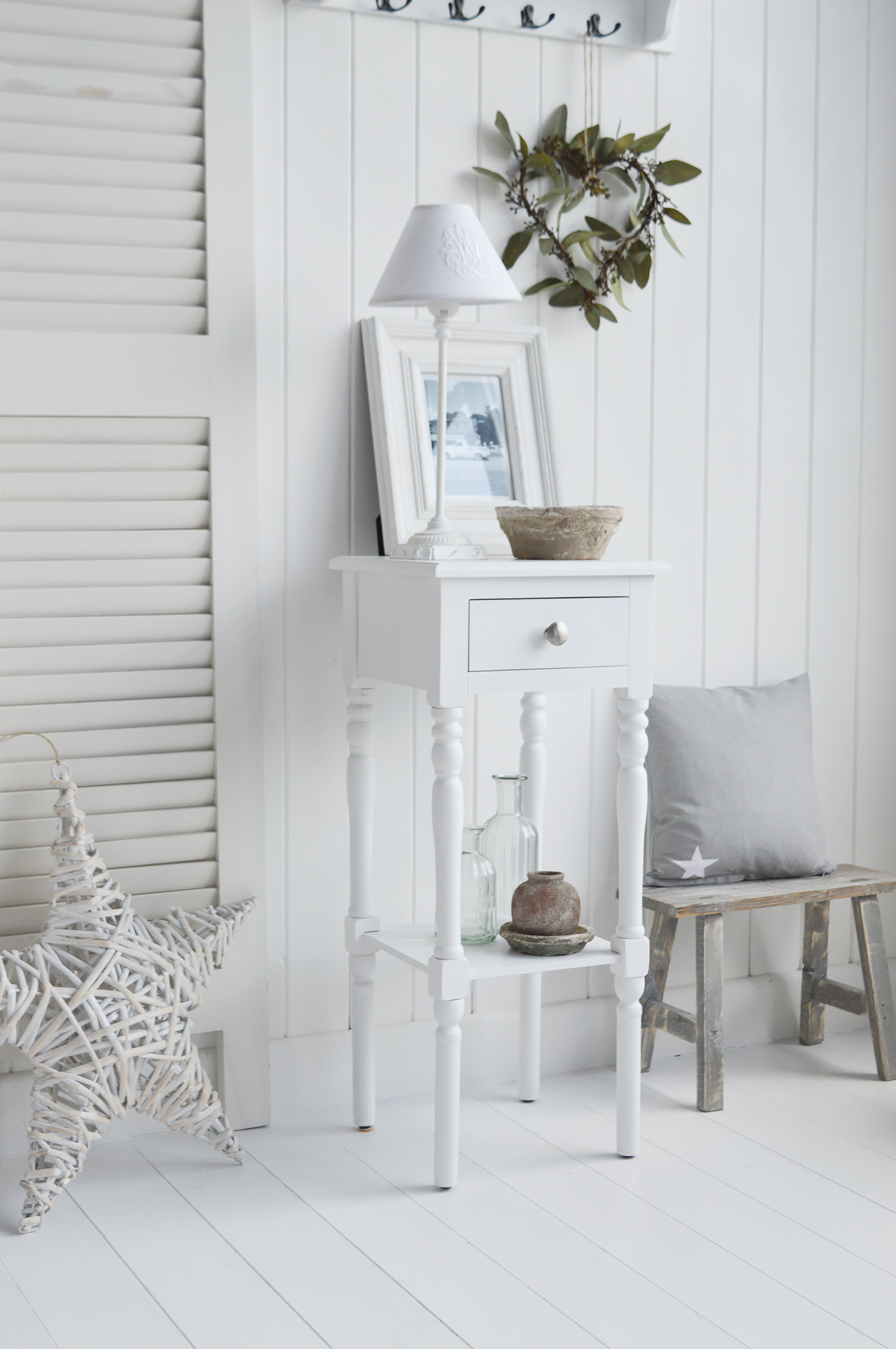 The White Lighthouse bedroom furniture. A narrow white bedside table with drawer and silver handle, can be used as a white lamp table from The Georgetown range