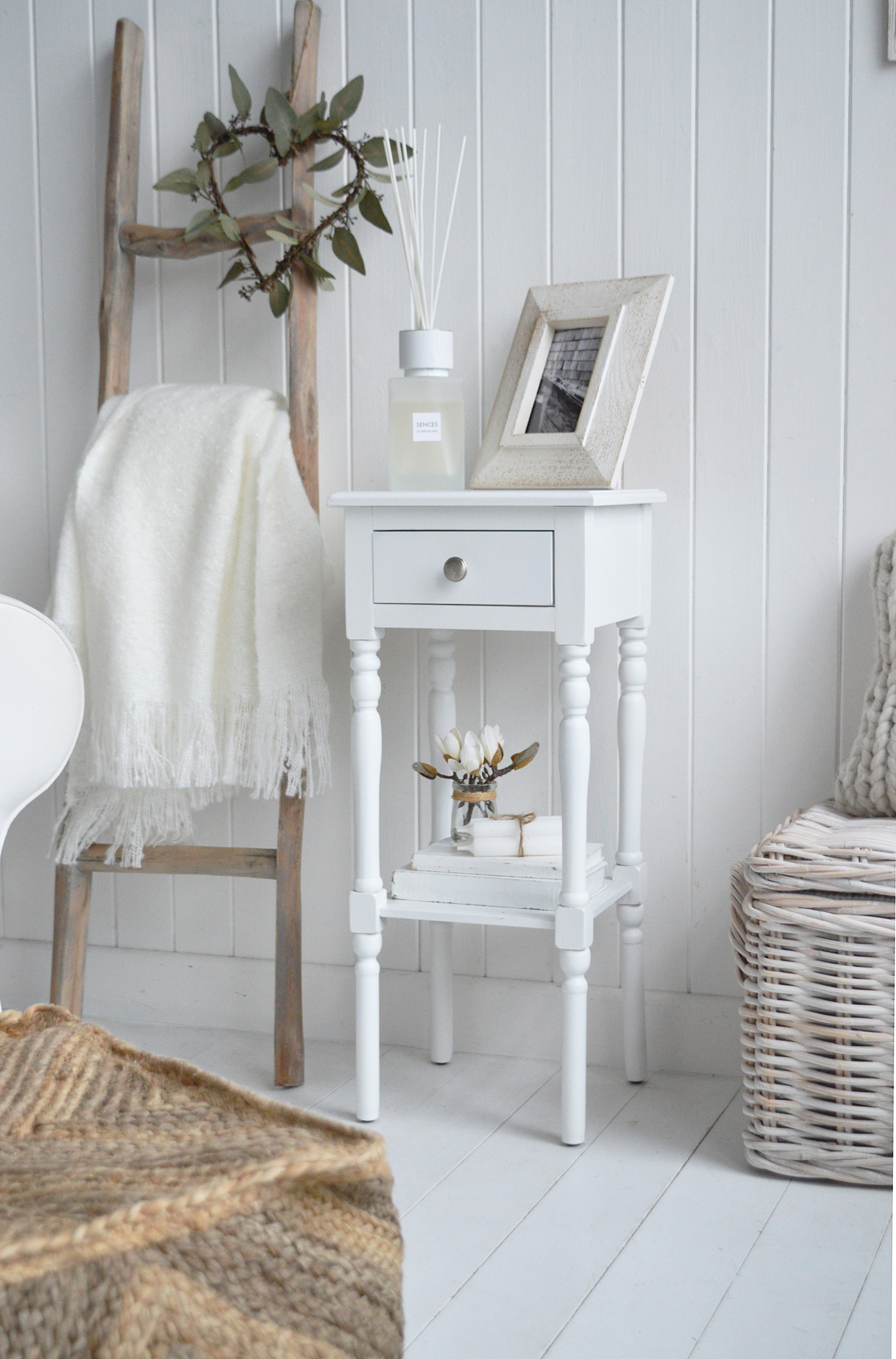 The Georgetown white narrow slim bedside table from the side to show the drawer and shelf along the white white diffuser