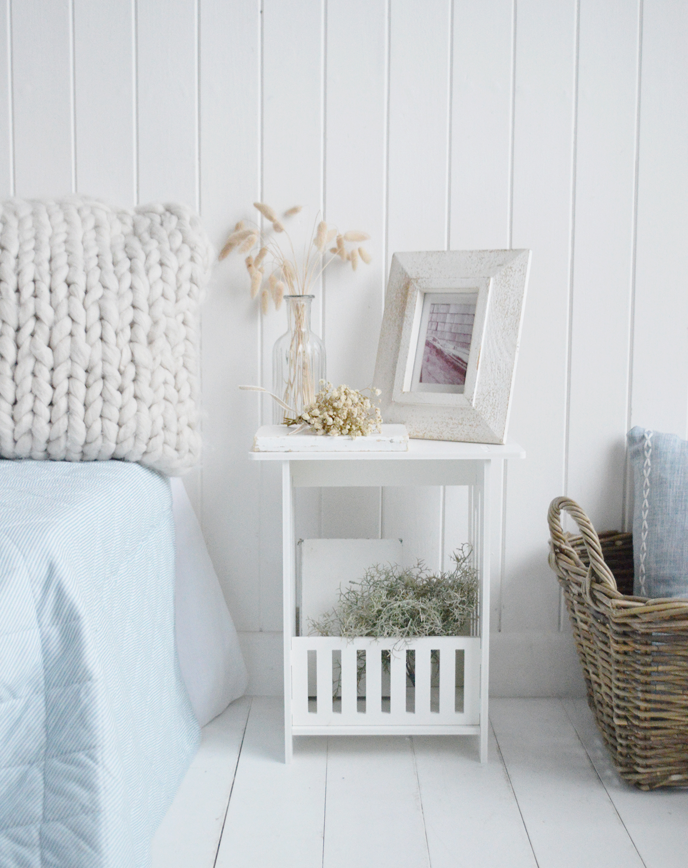 This narrow white bedside table is ideal for coastal interiors where space and simplicity matter.