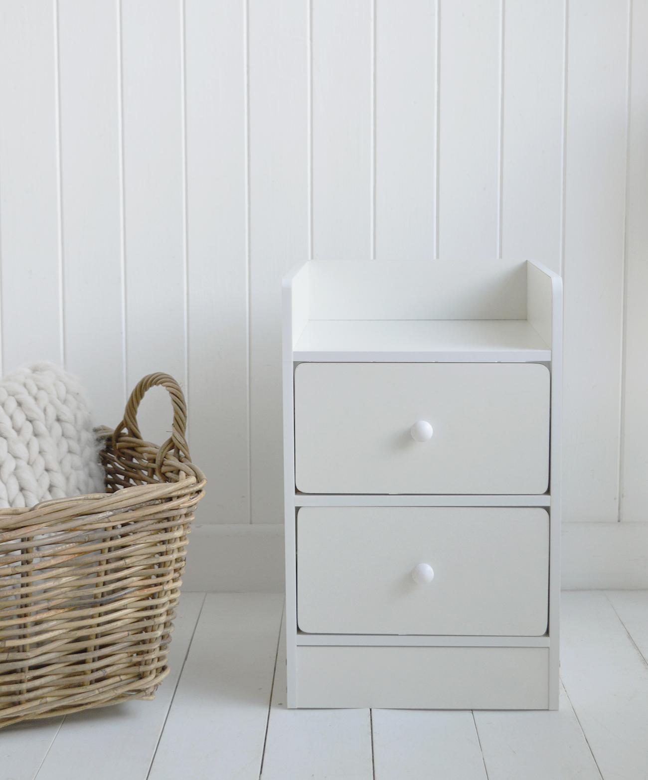 This two drawer white bedside table adds classic storage to coastal and modern country homes.