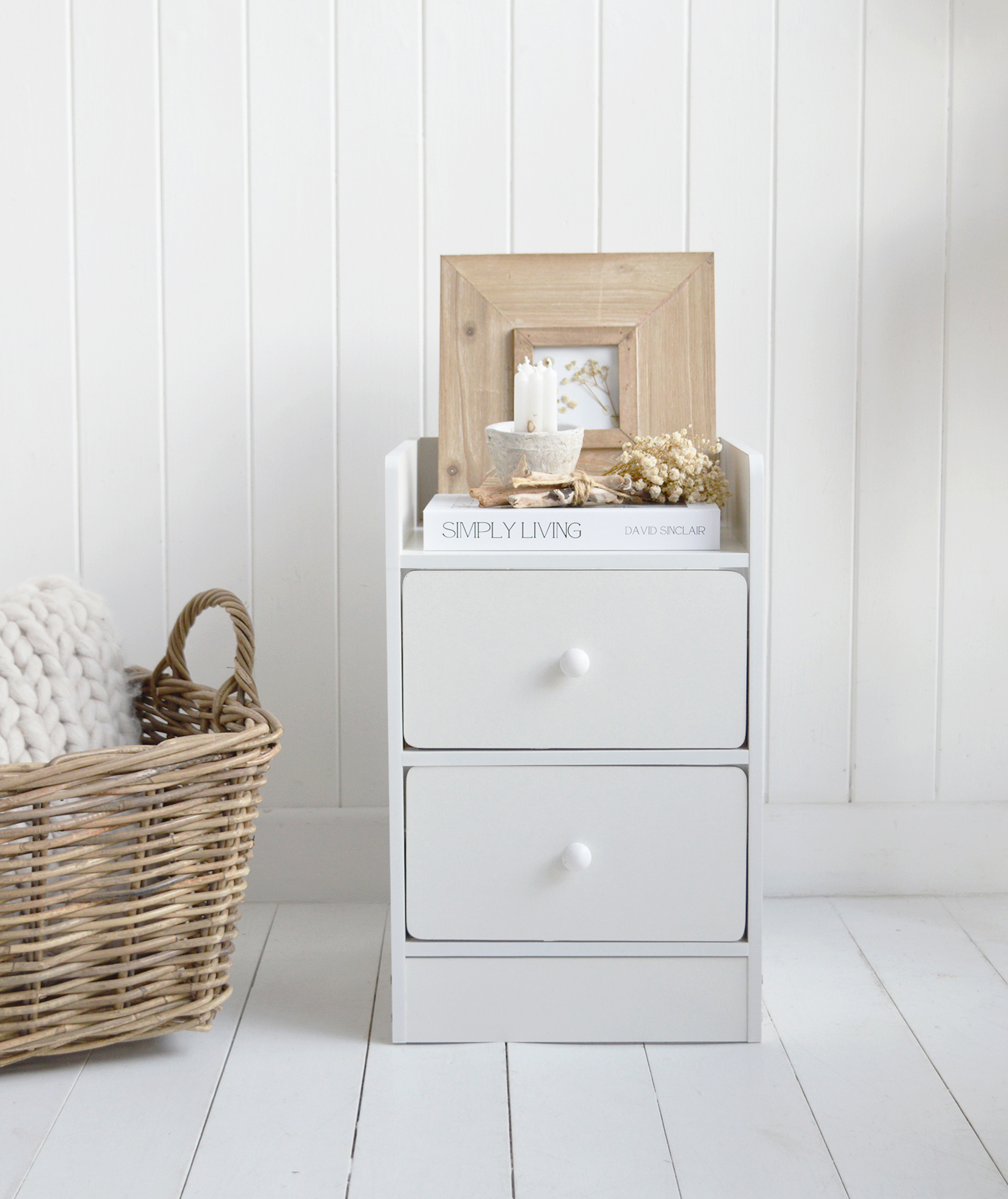 The Lindford white bedside table is perfect for New England style bedrooms and neutral interior schemes.