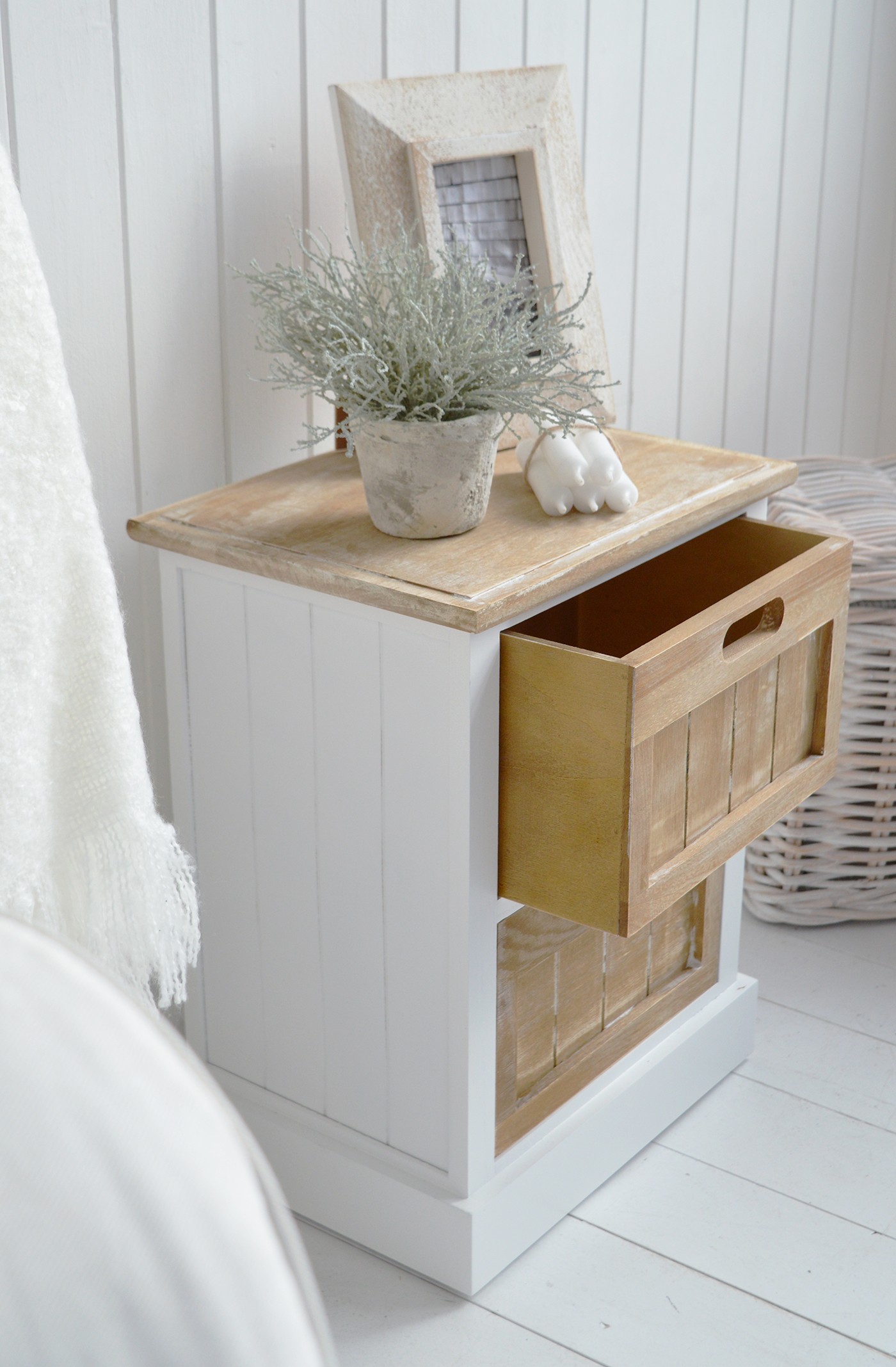 A white cabinet with 2 drawers from Maine range 