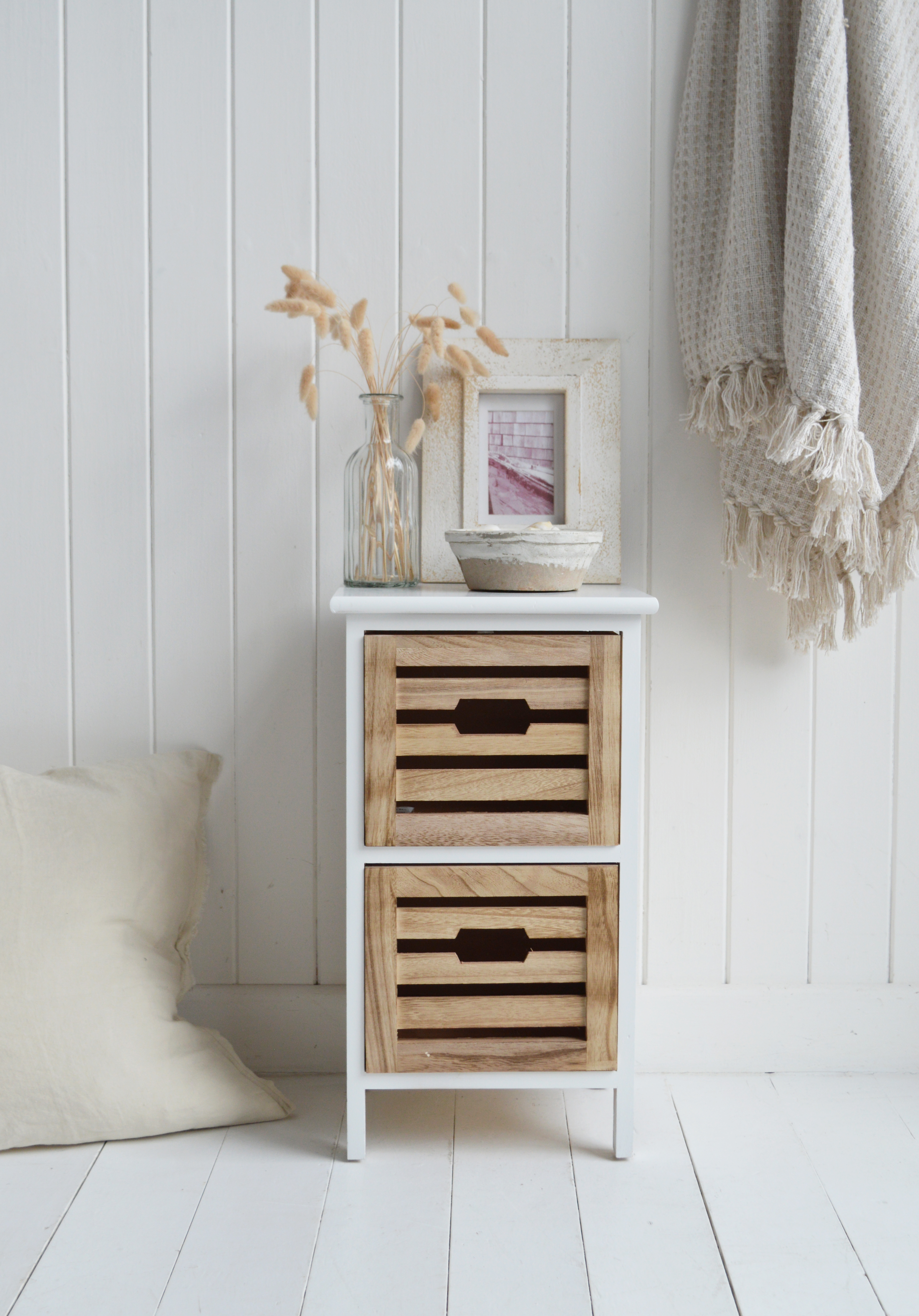 Space-saving narrow bedside table with two slatted wood drawers and clean white frame