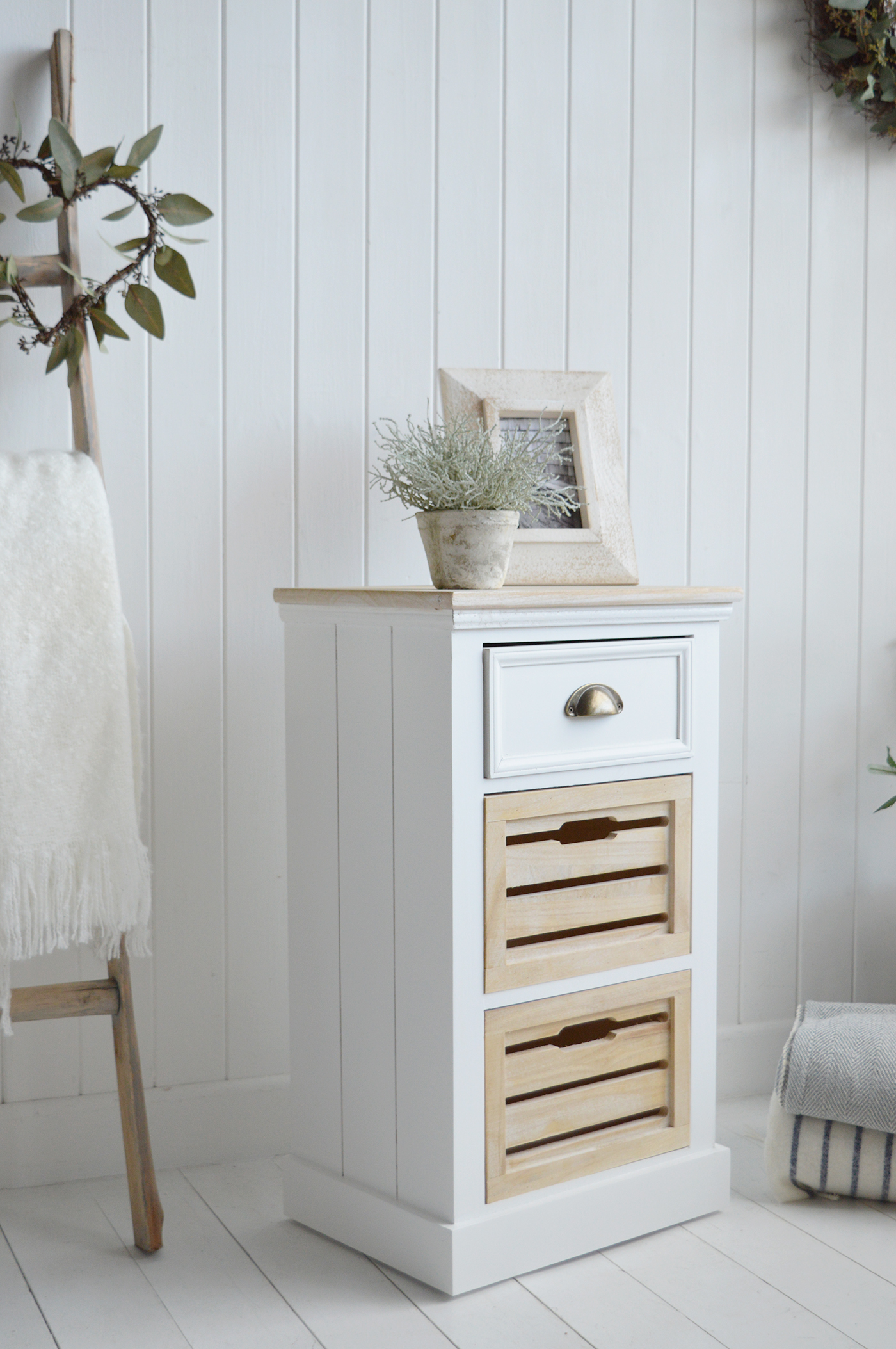 The Southport White Cabinet with three drawers - A Bedside or Lamp Table for Modern Country, Farmhouse and Coastal Furniture. The calming tones of the white washed wood of the drawers and top, against the white body lend to a light and airy feel to your space