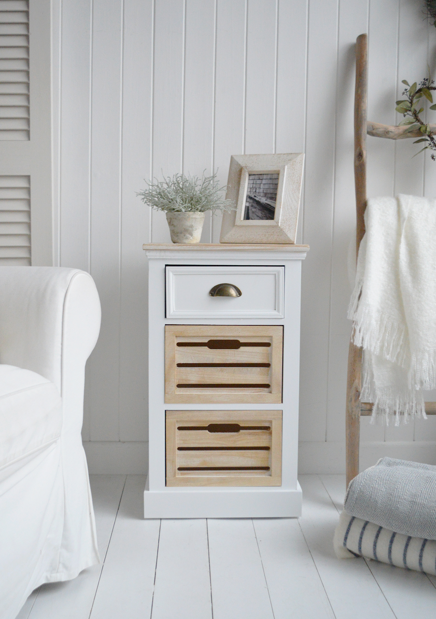 The white Southport cabinet as a lamp table with drawers for storage in a modern country farmhouse home