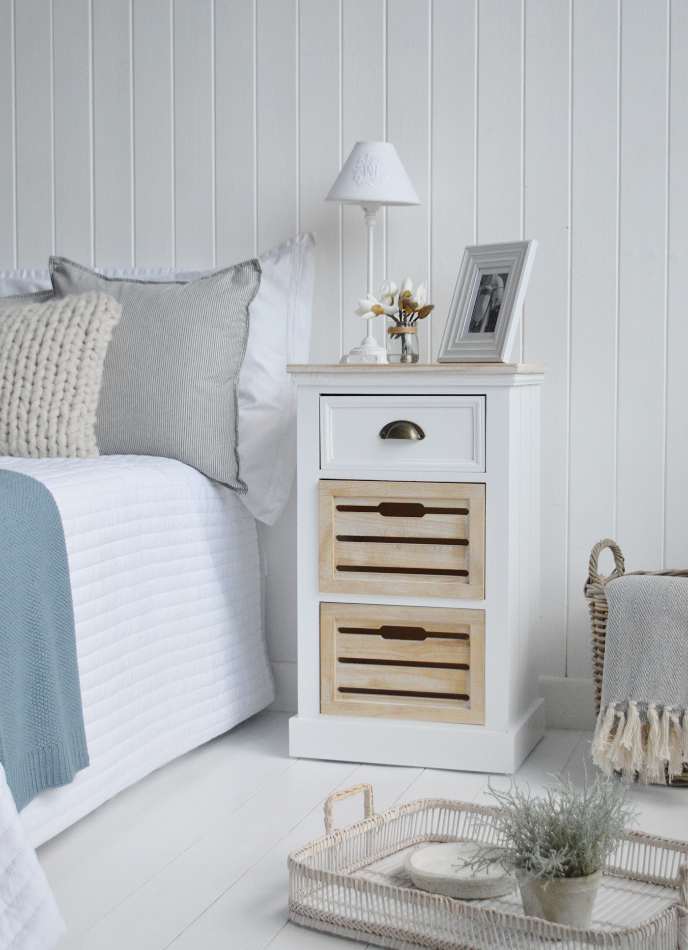 The Southport white bedside table with three drawers in a traditional clapboard finish for a modern coastal feel interior