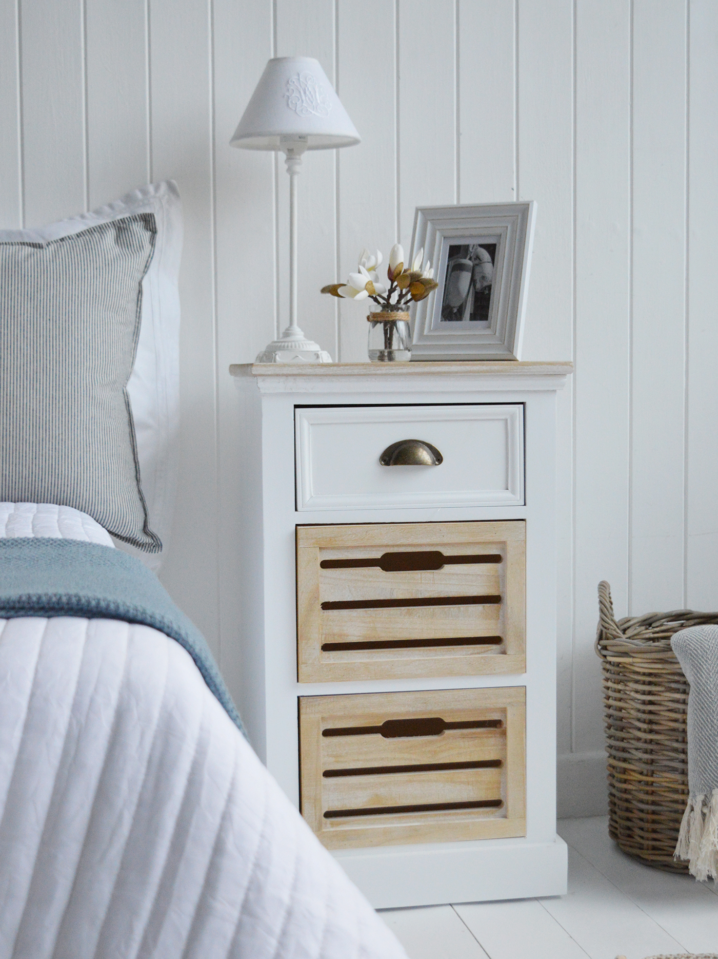 A coastal styled bedside cabinet in white and driftwood for a coastally inspired bedroom