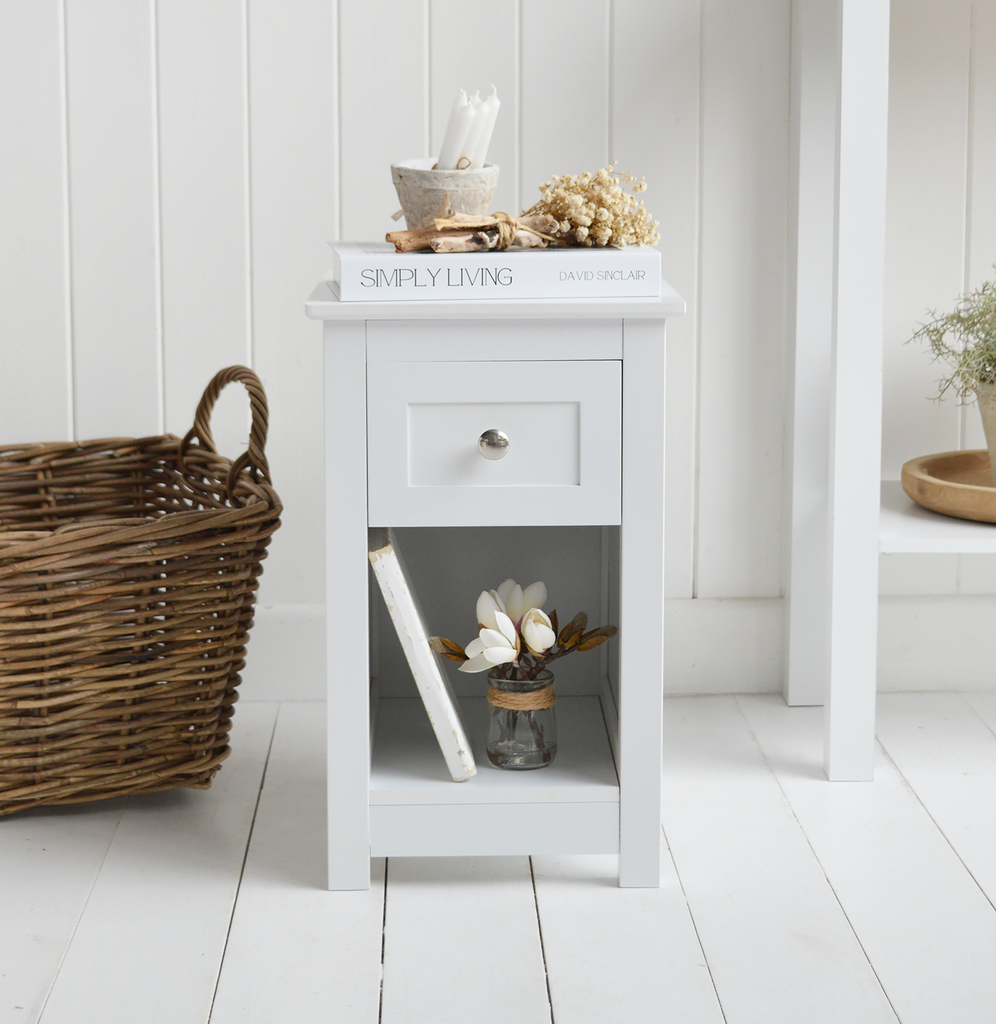 The Whitby white bedside table is designed for New England style bedrooms and calm neutral interiors.
