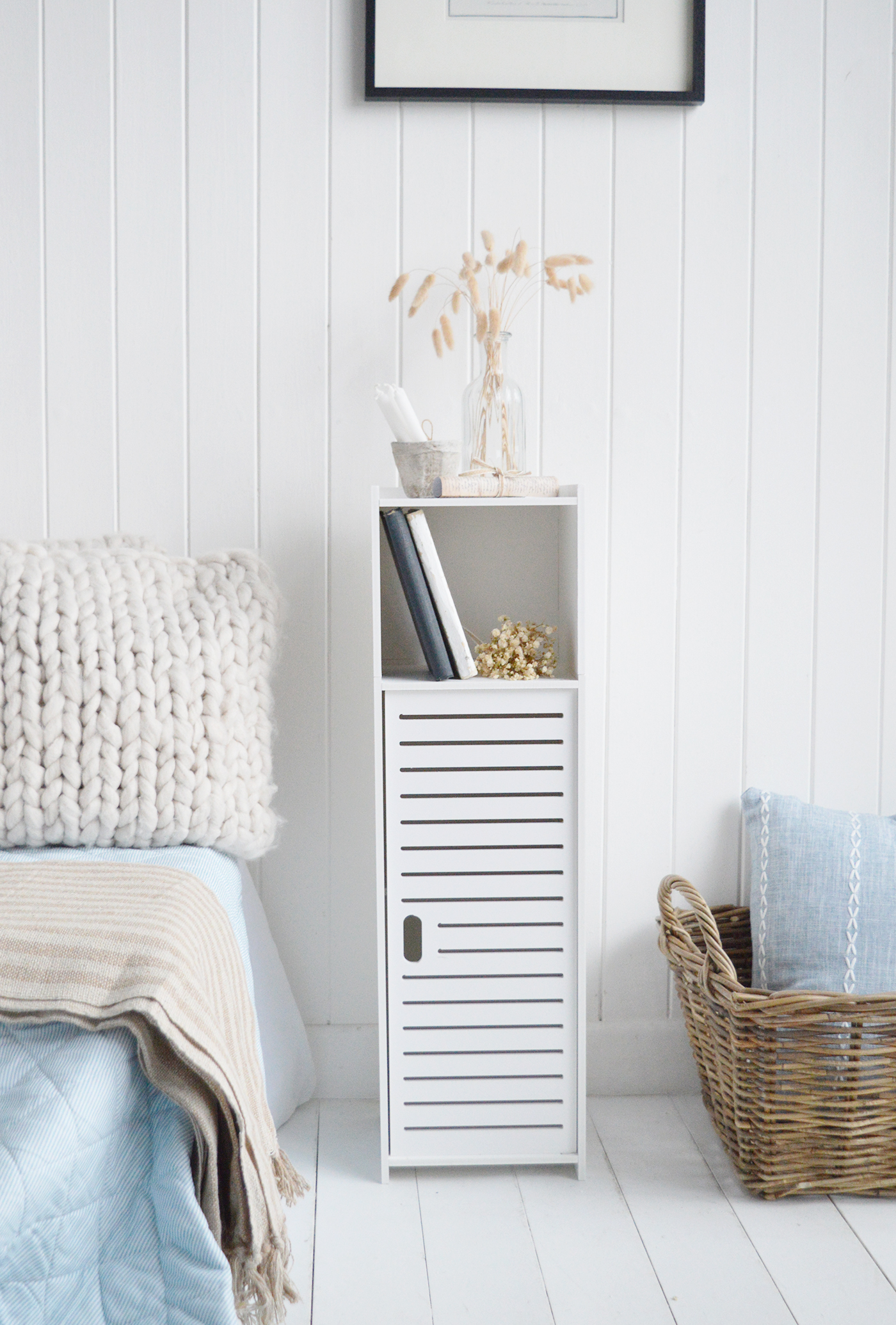 The Alden white narrow bedside cabinet is perfect for New England interiors, offering slim line storage with a clean, neutral aesthetic.