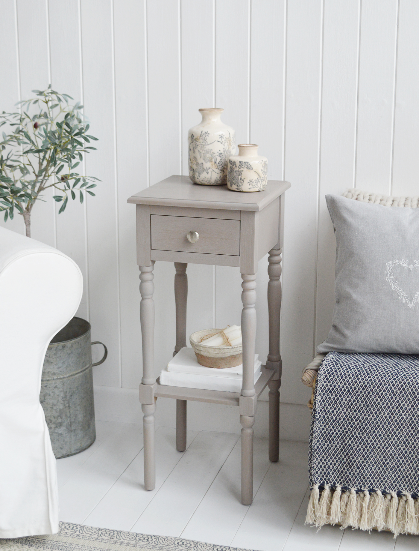 A large and narrow vintage grey lamp table with drawer and silver handle, ideal as bedside or in the living room of New England style coastal, country, beach house, Hamptons or modern Farmhouse styled home and interio